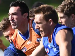 Michael Firrito of the Kangaroos (centre) and Drew Petrie of the Kangaroos during training in Melbourne, Wednesday, Aug. 24, 2016. The Kangaroos have decided not to renew the contracts of Brent Harvey, Drew Petrie, Michael Firrito and Nick Dal Santo. (AAP Image/Tracey Nearmy) NO ARCHIVING