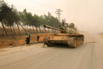 A tank for rebel fighters drives in Dahiyat al-Assad west Aleppo city.