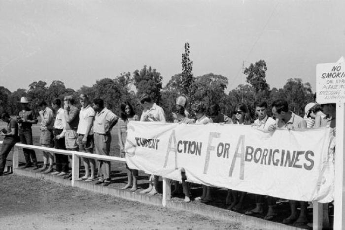 People hold up SAFA sign