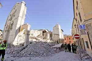 Monks walk in front of the Cathedral of St. Benedict in Norcia, central Italy, Italy, Monday, Oct. 31, 2016. The third powerful earthquake to hit Italy in two months spared human life Sunday but struck at the nation's identity, destroying a Benedictine cathedral.