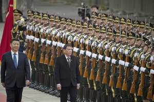 Philippine President Rodrigo Duterte, center, walks with Chinese President Xi Jinping during a welcome ceremony outside the Great Hall of the People in Beijing, China, Thursday, Oct. 20, 2016.