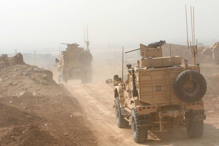 Peshmerga military vehicles drive north of Mosul