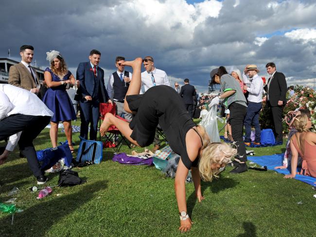 Punters enjoying themselves after the running of the Melbourne Cup, at Flemington Racecourse.