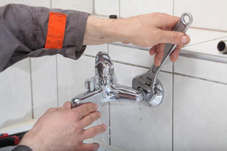 plumber changing washers taps