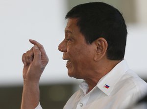 Philippine President Rodrigo Duterte gestures during a news conference prior to boarding his flight for a three-day official visit to Japan at the Ninoy Aquino International Airport in suburban Pasay city south of Manila, Philippines Tuesday, Oct. 25, 2016.