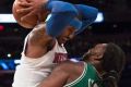 Knicks forward Carmelo Anthony holds the ball away from Celtics forward Jae Crowder during a preseason game at Madison ...