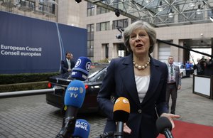 British Prime Minister Theresa May talks to the media as she arrives for the first day of the EU Summit in Brussels, Belgium, Thursday, Oct. 20, 2016.