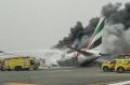 Crews work to extinguish a fire on Emirates flight EK521 after it was involved in an accident.