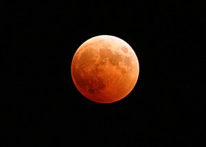 The moon turns red and orange during a total lunar eclipse.