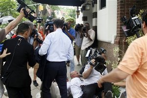 News photographers fall while scrambling to cover Anthony Weiner, as he return home from a news conference, Thursday, June 16, 2011, in the Queens borough of New York. Weiner resigned from Congress, saying he cannot continue in office amid the intense controversy surrounding sexually explicit messages he sent online to several women. (AP Photo/Bebeto Matthews)