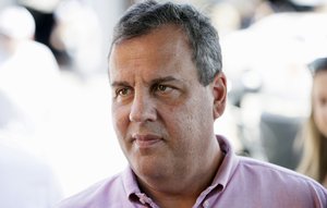 Republican presidential candidate, New Jersey Gov. Chris Christie talks with drivers in the garage area before the NASCAR Xfinity Series auto race, Saturday, Aug. 1, 2015, at Iowa Speedway in Newton, Iowa.