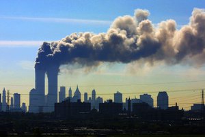 In this Sept. 11, 2001 file photo, as seen from the New Jersey Turnpike near Kearny, N.J., smoke billows from the twin towers of the World Trade Center in New York after airplanes crashed into both towers.