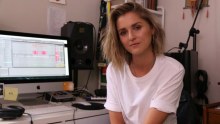 Musician KLP sitting at her desk. 