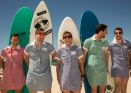 Guys and girls get frocked up on Bondi beach for a surf in a dress to raise money to help girls in West Africa gain ...