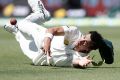 Australia's Mitchell Starc crashes on the ground as he tries to catch out South Africa's Dean Elgar on the third day of ...