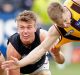 Carlton's Patrick Cripps drags down Sam Mitchell.