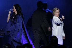 Katy Perry, left, addresses the crowd during a concert supporting Democratic presidential candidate, Hillary Clinton, right, at the Mann Center for the Performing Arts, Saturday, Nov. 5, 2016, in Philadelphia.