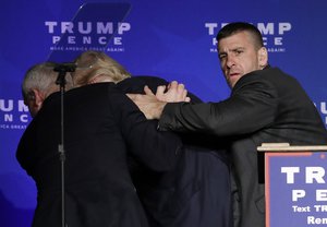 Secret Service agents rush Republican presidential candidate Donald Trump off the stage during a campaign rally in Reno, Nev.