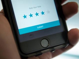 (FILES) This file photo taken on February 12, 2016 shows the driver rating screen in an Uber app is seen in Washington, DC. Uber on November 2, 2016 began rolling out an overhauled smartphone application that uses artificial intelligence in a bid to speed up and improve the ride-sharing experience. The update is the first major overhaul for the popular application since 2012 and aims to simplify usage for a service that has added new travel options such as uberPool to share rides among several travelers. / AFP PHOTO / Brendan Smialowski