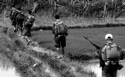 NPA on patrol in the rice paddies (photo courtesy of InterAksyon)