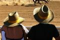 Horses race in Birdsville at an iconic outback event, started in 1882, that draws people from everywhere to the remote ...