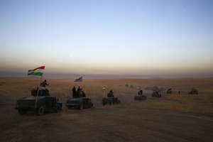 In this Monday, Oct. 17, 2016 file photo, a Peshmerga convoy drives towards a frontline in Khazer, about 30 kilometers (19 miles) east of Mosul, Iraq.