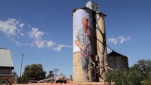 A mural by Fintan Magee of farmer Nick Hulland, painted on the Patchewollock silos.