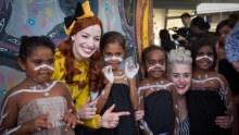 Emma the Yellow Wiggle with children in Yarrabah.