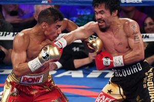 Fight night: Jessie Vargas and Manny Pacquiao battle in the third round.
