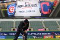 A member of the Cleveland Indians grounds crew paints the World Series logo on the field prior to Media Day at ...