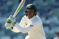 Usman Khawaja leads Australia on a daunting second-innings run chase.