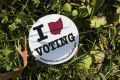 An Ohio voting sticker sits on the grass during early voting outside of the Fairfield County Board of Elections Office ...