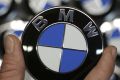 An employee holds a BMW logo on the production line of the BMW C evolution electric maxi-scooter at the BMW Berlin ...