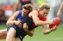 MELBOURNE, AUSTRALIA - MAY 22:  Jayden Hunt of the Demons handballs whilst being tackled  during the round nine AFL ...