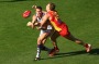 GOLD COAST, AUSTRALIA - JULY 23:  Jonathon Griffin of the Dockers handballs while tackled by Tom Lynch of the Suns ...