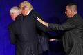 Members of the Secret Service rush Republican presidential candidate Donald Trump off the stage at a campaign rally in ...
