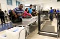 Passengers pass through security screening at Los Angeles International Airport.