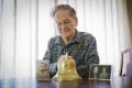 Unique souvenir: Watson resident Frank Atkinson reflects on the bell his father Frank brought home from Gallipoli.