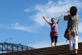 Chinese tourists take photographs in front of the Sydney Harbour.