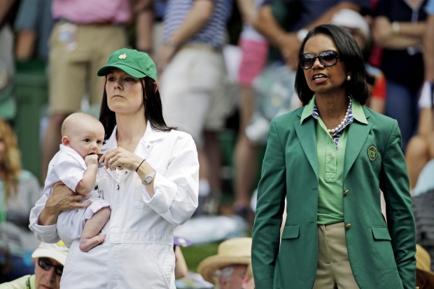 Brendan Todd's wife Rachael holding their son Oliver stands next to former Secretary of State Condoleeza Rice.