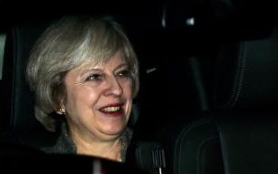 Britain's Prime Minister Theresa May looks on as she sits in the car upon her arrival at the airport in New Delhi on November 6, 2016