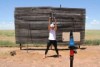 Joy McClymont recording a fitness video in the tennis court on her family's property. 