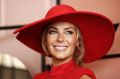 Jennifer Hawkins in a red jumpsuit by Misha Collection. And hat.