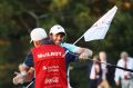 Rory McIlroy celebrates with his caddie J.P. Fitzgerald after holing a birdie putt at East Lake Golf Club.