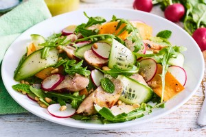 Radish, carrot, cucumber and mint salad with pork sausages