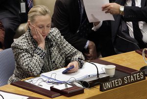 In this March 12, 2012 file photo, then-Secretary of State Hillary Rodham Clinton checks her mobile phone after her address to the Security Council at United Nations headquarters.