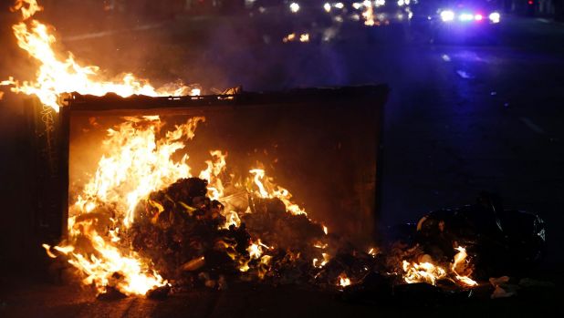 A fire burns during protests in Oakland, Calif., late Tuesday, Nov. 8, 2016. President-elect Donald Trump?s victory set ...