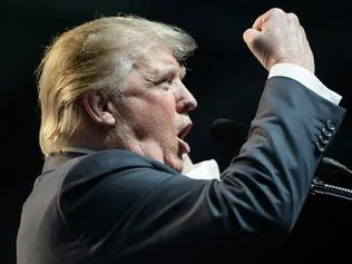 (FILES) This file photo taken on May 5, 2016 shows US Republican presidential candidate Donald Trump speaking during a rally in Charleston, West Virginia. Donald Trump said on November 9, 2016 he would bind the nation's deep wounds and be a president "for all Americans," as he praised his defeated rival Hillary Clinton for her years of public service. / AFP PHOTO / Brendan Smialowski