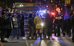 Police confront protesters during a demonstration against President-elect Donald Trump, early Wednesday, Nov. 9, 2016, in Seattle's Capitol Hill neighborhood.