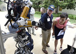 File - Dr. Tom McKenna, a program officer with the Office of Naval Research, talks to Dr. Janine Davidson, undersecretary of the Navy, about the Shipboard Autonomous Firefighting Robot during a Technology Innovation Day event at the Pentagon, June 24, 2016.